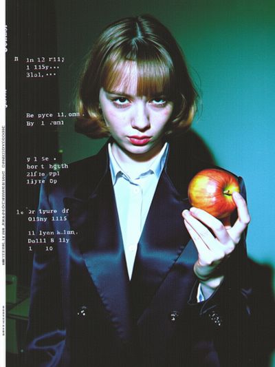 a girl is holding an apple